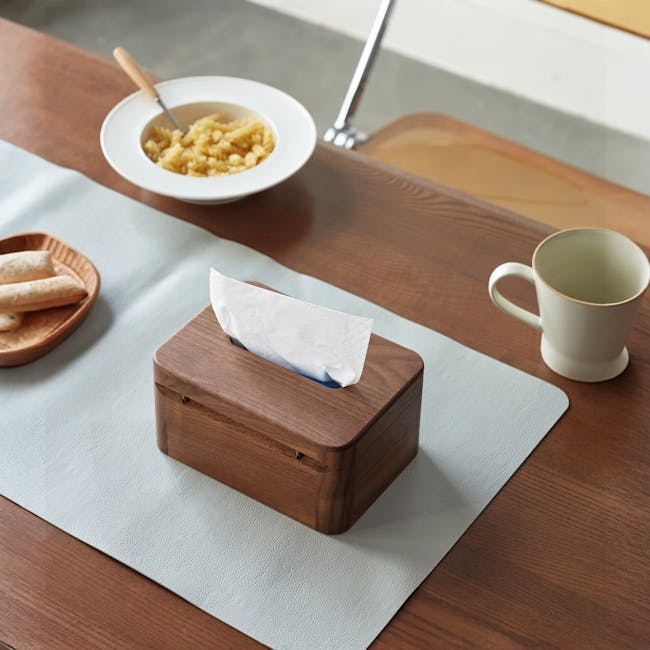 Kenji Tissue Box - 7 - Wooden box with tissue, wooden table, light gray placemat, wooden spoon, wooden bowl with pasta