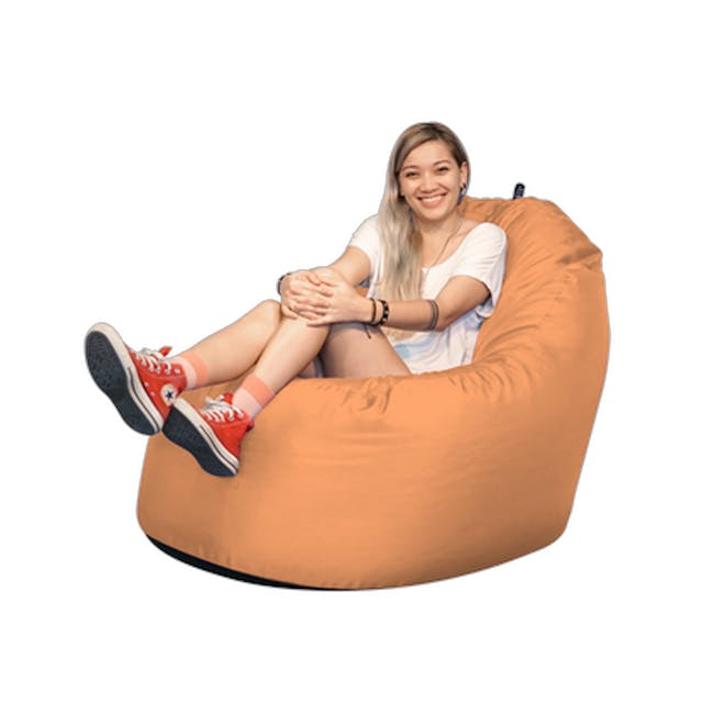 Doob Oomph Water-Repellent Bean Bag Chair - Apricot Crush (2 Sizes) - 2 - woman sitting on bean bag chair, casual attire