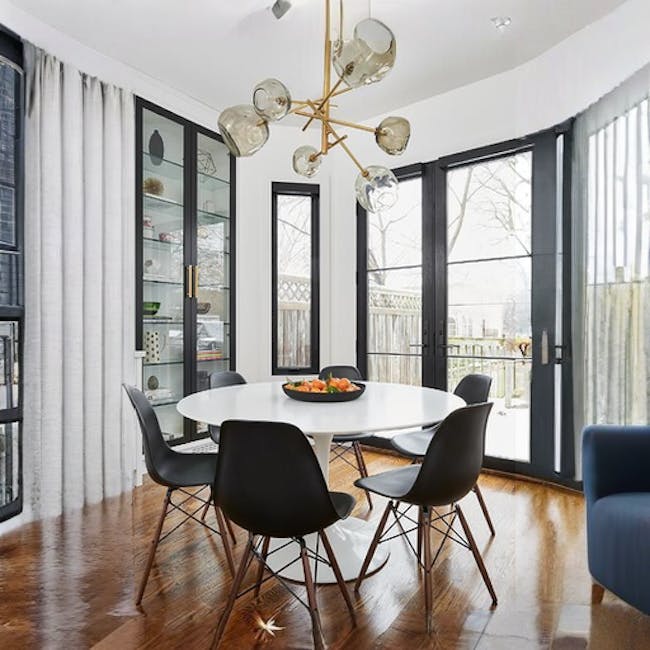 Carmen Round Dining Table 1m - White - 6 - Modern dining room with sleek black chairs and a white round table, large