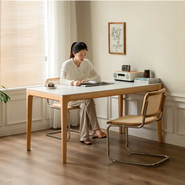 Adelyn Dining Table 1.6m - Oak (Sintered Stone) - 15 - Sunlit room, woman reading, cozy atmosphere, wooden table, light
