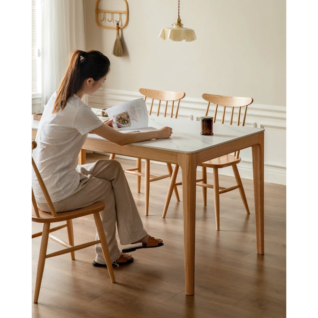 Adelyn Dining Table 1.6m (Sintered Stone) with 4 Niel Chairs in Oak - 7 - Light streaming through window, woman reading