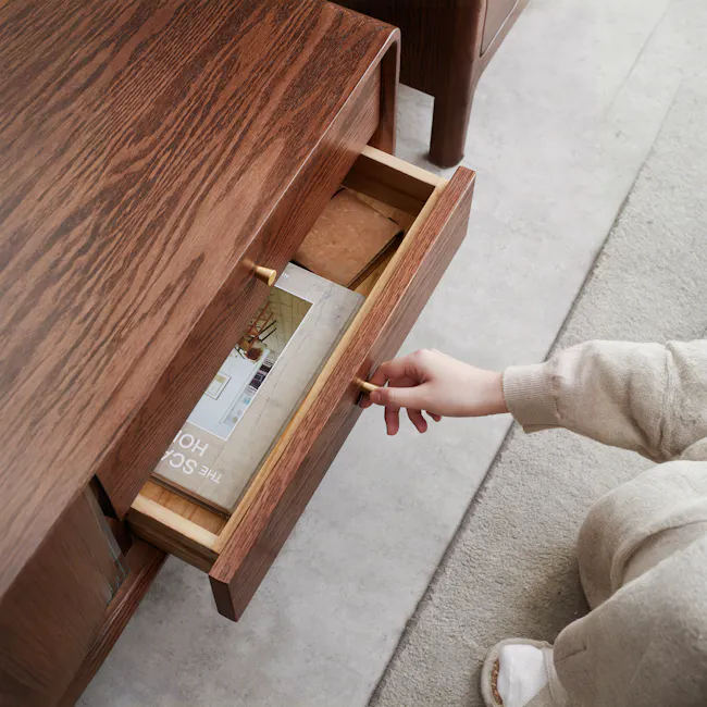 Lucia TV Console 2.2m - 6 - Wooden drawer, open drawer, person's hand, beige sweater sleeve, floor, light-colored carpet