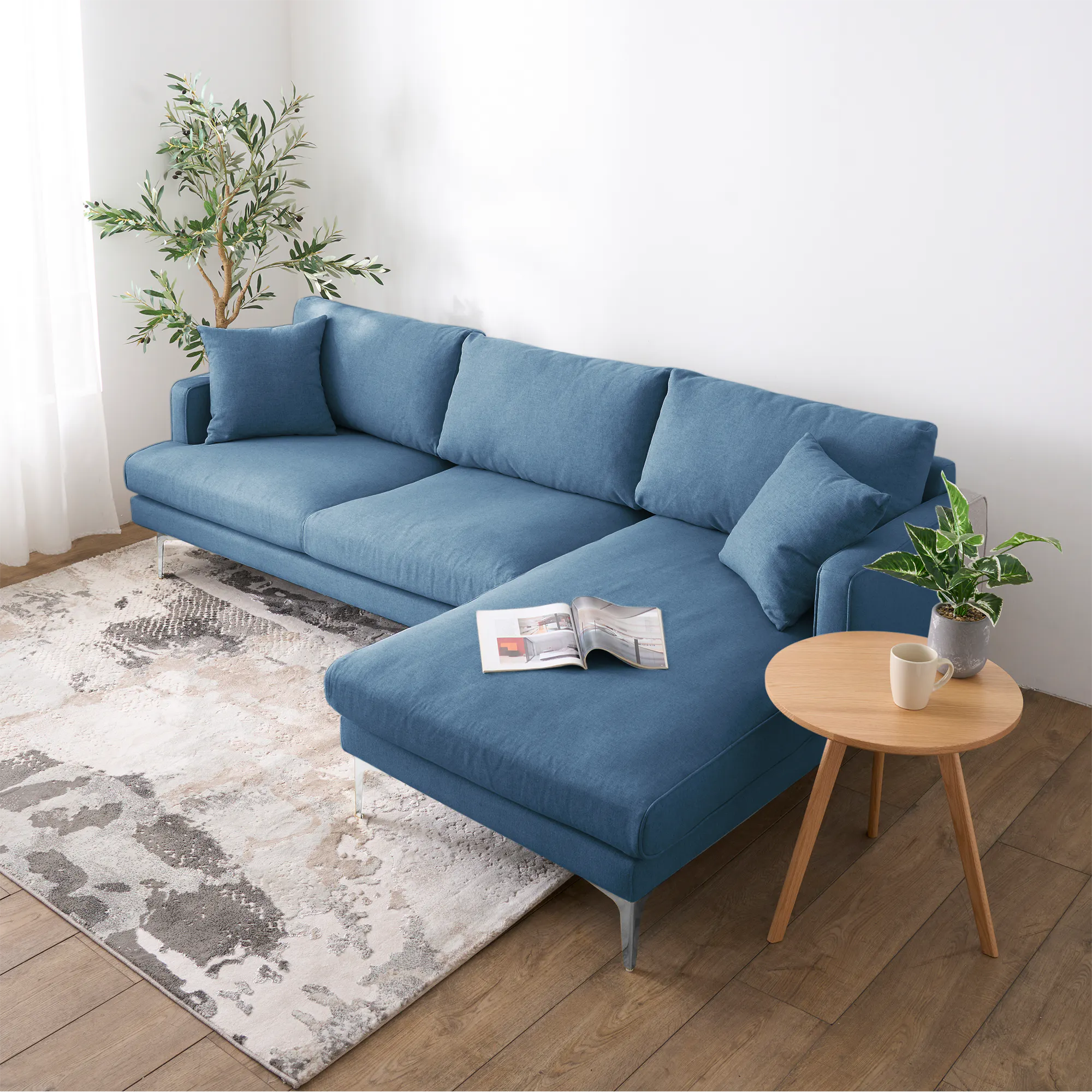 Declan L-Shaped Sofa - Walnut, Blue - 23 - Modern living room, cozy sofa, blue fabric, wooden floor, white curtains, green