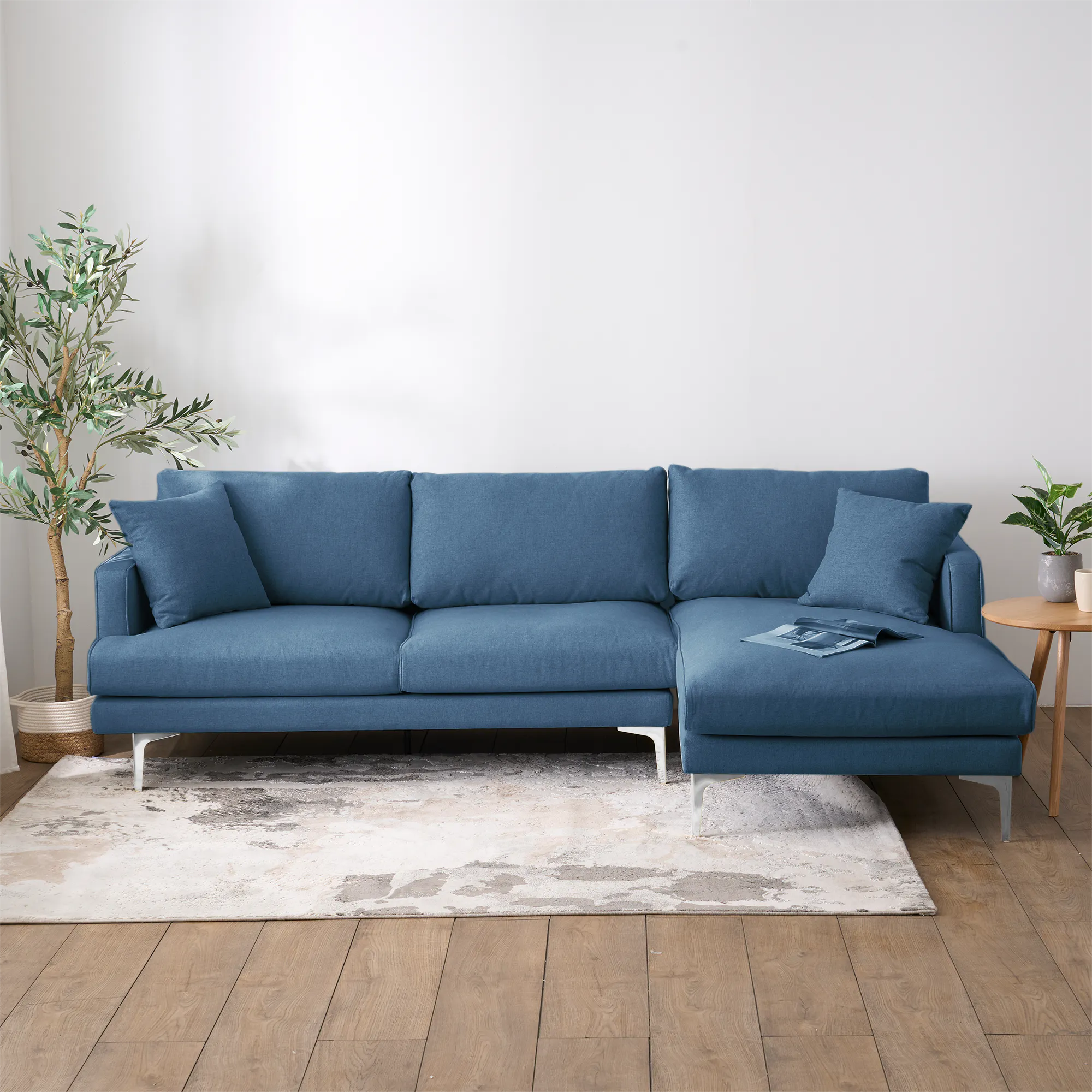 Declan L-Shaped Sofa - Walnut, Blue - 25 - Modern living room, cozy sofa, blue fabric, wooden floor, white rug, potted
