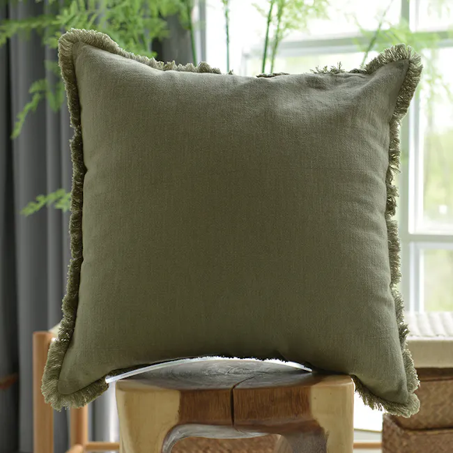 Scylla Fringe Cushion Cover - Olive - 2 - Elegant throw pillow, rustic texture, green fabric, fringed edges, natural wood