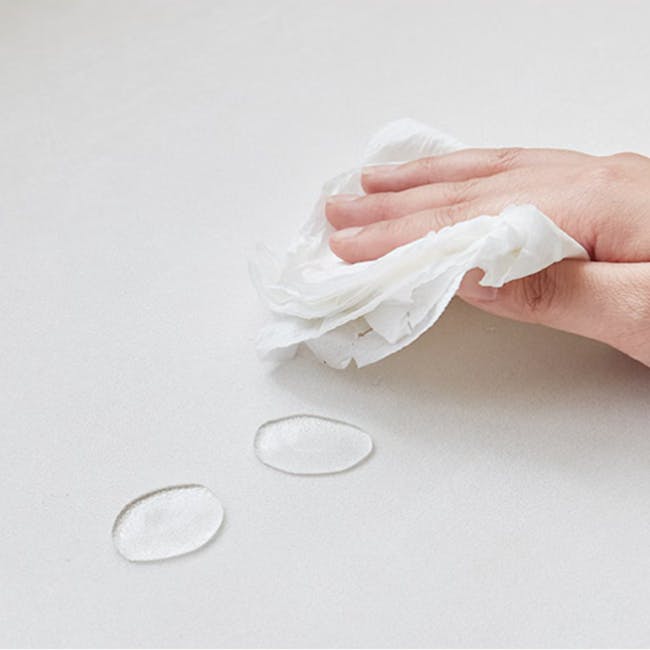 Lusa Left Arm - Ivory (Pet Friendly) - 16 - Hand holding crumpled tissue, paper towel, wiping surface, white background