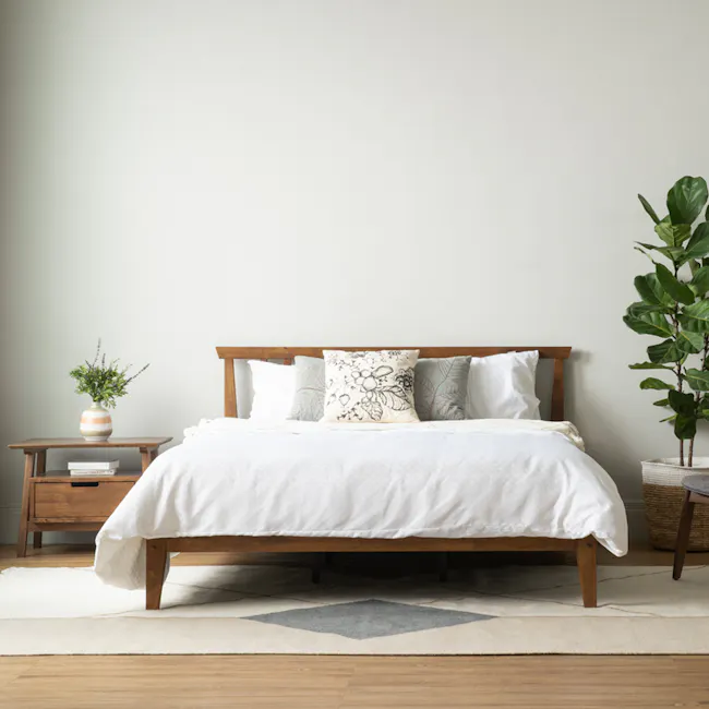 Topal Queen Bed - Cocoa - 6 - Wooden bed with white comforter, minimalist decor, natural light, green plants, textured