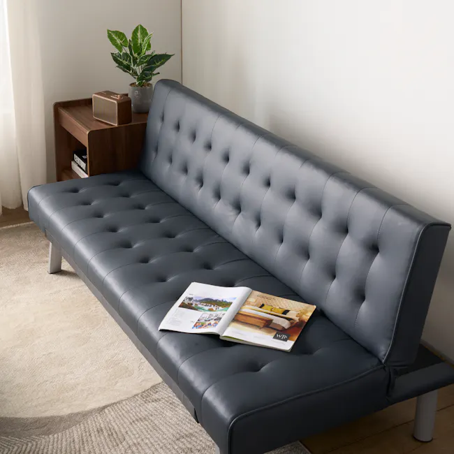 Julia 3 Seater Sofa Bed - Slate Grey (Faux Leather) - 6 - Modern gray tufted sofa, minimalist decor, soft lighting, potted