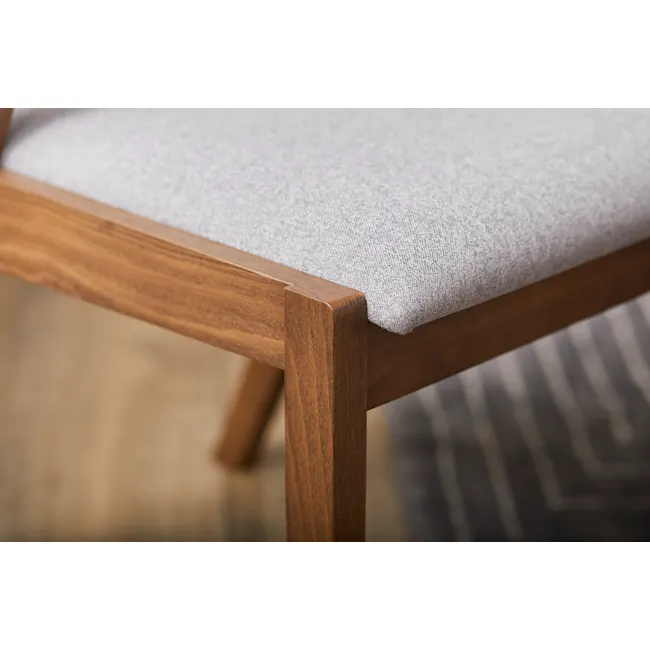 Imogen Dining Chair - Cocoa, Dolphin Grey (Fabric) - 11 - Wooden chair with gray cushion, close-up view, natural wood grain