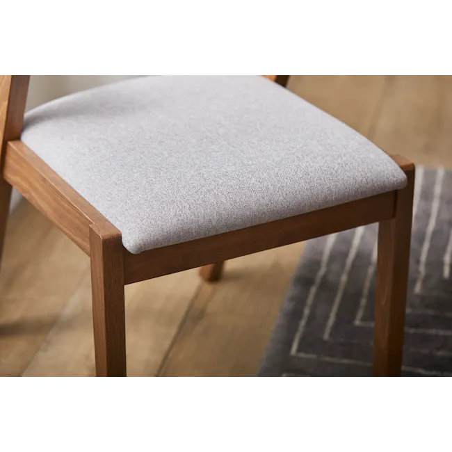 Imogen Dining Chair - Cocoa, Dolphin Grey (Fabric) - 12 - Wooden chair with light gray cushion, close-up view, natural wood