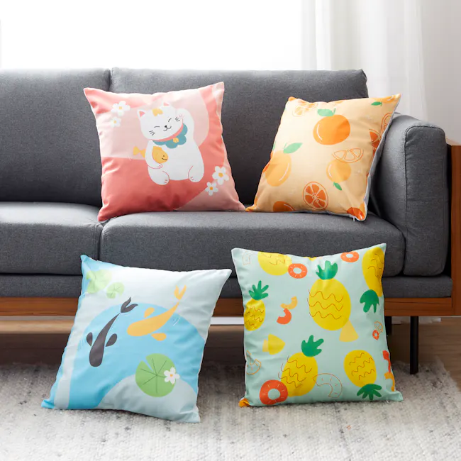 Harmony Koi Cushion - 2 - Colorful pillows on gray sofa, orange and yellow citrus-themed pillows, light blue pillow with