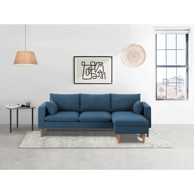 Alicia L-Shaped Sofa - Blue - 4 - Modern minimalist living room, contemporary blue sofa, abstract art on white wall, natural