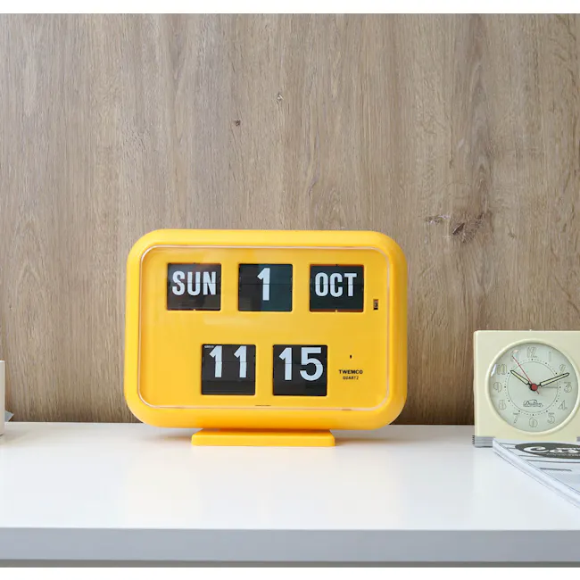 TWEMCO Big Calendar Flip Wall Clock - Yellow - 2 - Yellow digital clock, "SUN 1 OCT" display, "11:15" time, "TWEMCO" brand