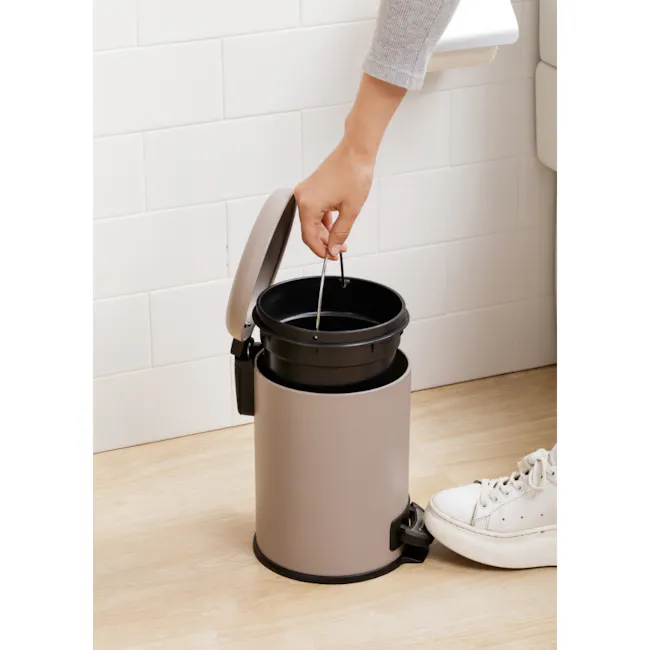 Tatay Nordic Stainless Steel Dustbin 3L - Taupe - 6 - Gray and black trash bin, person scooping trash, white tiled wall