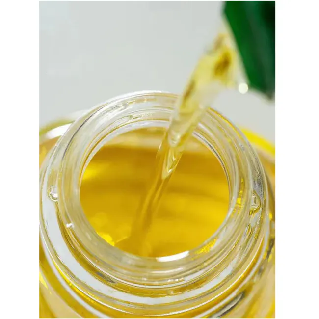 Zuutii Drip-Free Oil Carafe - Lemon Yellow - 12 - Golden liquid, pouring, transparent jar, golden hue, viscous texture, oil