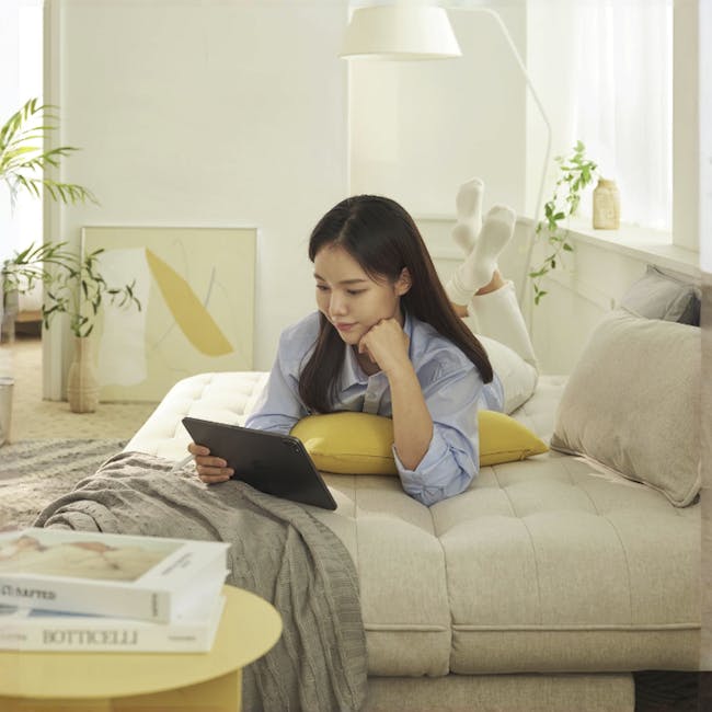 Tessa Storage Lounge Sofa Bed - Beige (Eco Clean Fabric) - 11 - Lay on beige couch, use tablet, long hair, white shirt