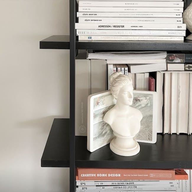 Fraser Bookshelf - 7 - Modern minimalist bookshelf with stacked books, White bust sculpture on black shelf, Stack of books