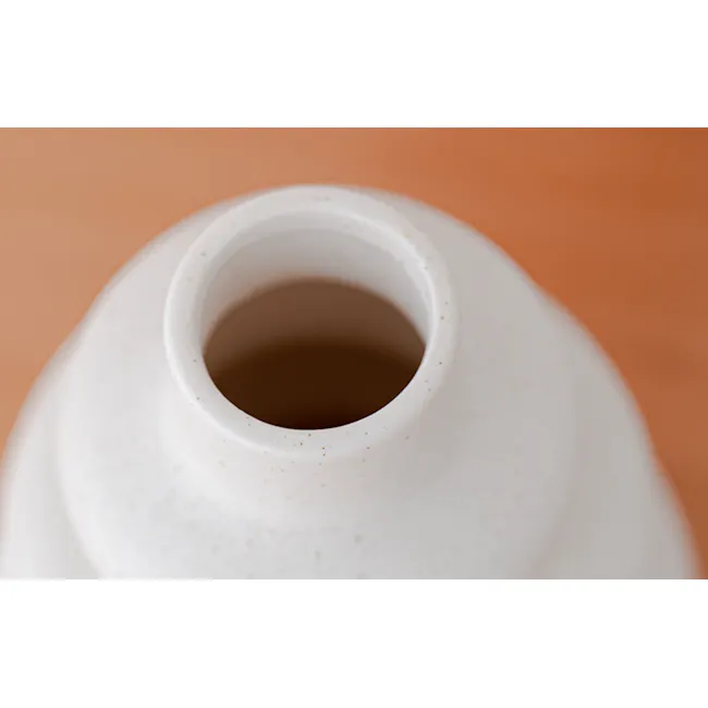 Lenny Ceramic Vase - 6 - White ceramic pitcher, brown liquid, small specks, smooth texture, shallow interior, minimalist