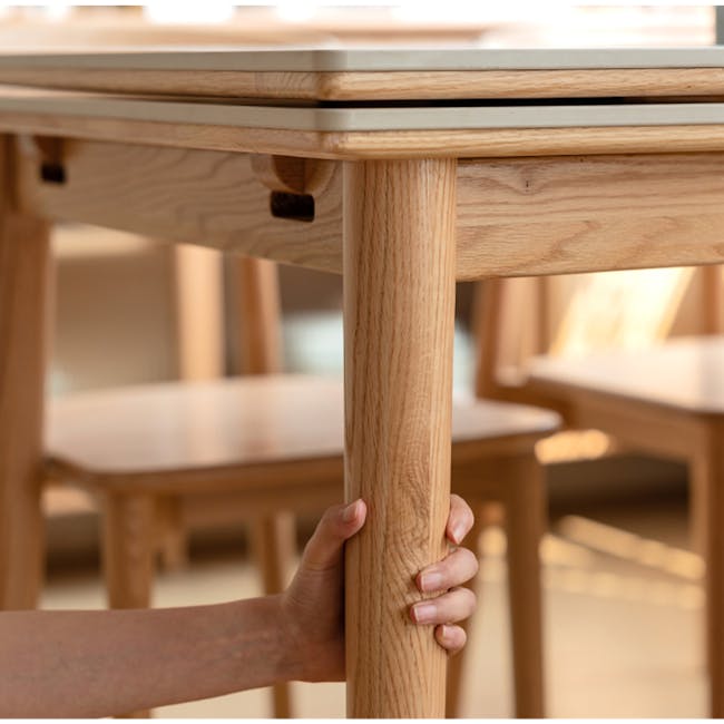 Fidela Extendable Dining Table 0.9m-1.5m (Sintered Stone) - 9 - Wooden table, wooden legs, hand holding table leg, indoor
