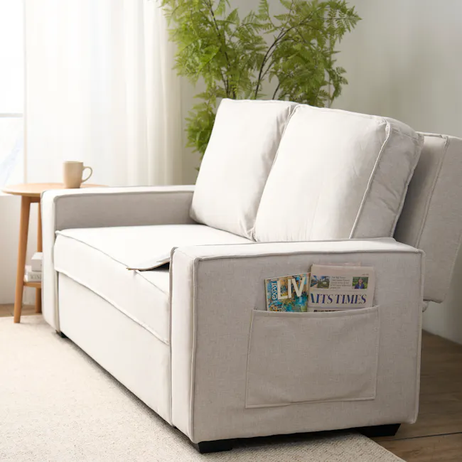 Arturo 2 Seater Sofa Bed - Beige (Eco Clean Fabric) - 19 - Light-colored sofa, beige cushions, magazine in pocket, cozy