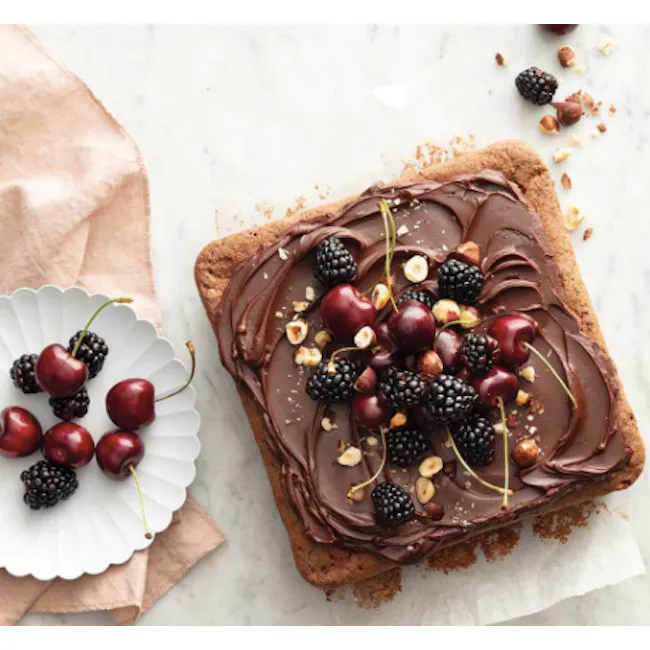 Wiltshire Rose Gold Square Cake Pan - 2 - Chocolate-topped tart with fresh berries and nuts, white plate with cherries
