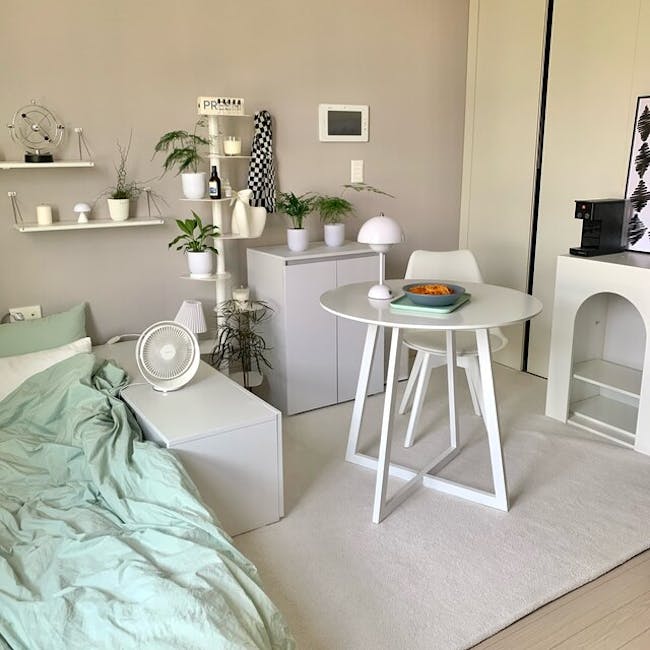 Muse Cabinet 0.6m - White - 5 - Modern minimalist bedroom with light beige walls, white furniture, and soft green bedding.