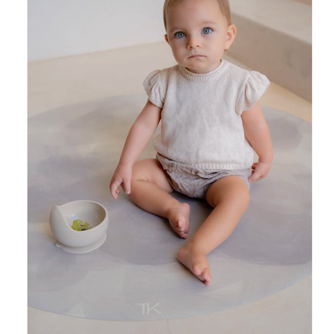 Toddlekind Prettier Round Splat Mat 1m - Clouds - 3 - Baby sitting on a circular mat, wearing a light-colored, short-sleeved