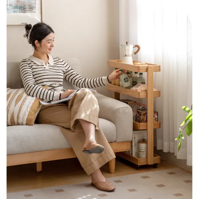 Fika 4-Tier Narrow Trolley 0.6m - Oak - 2 - Sitting on a comfortable sofa, woman reading a book, holding a notebook, wearing