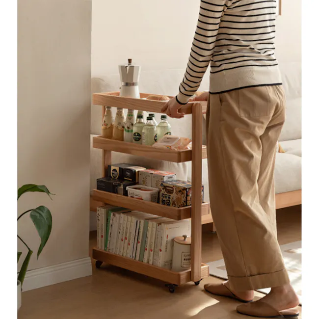 Fika 4-Tier Narrow Trolley 0.6m - Oak - 5 - Wooden cart with various items, person standing next to cart, beige pants and