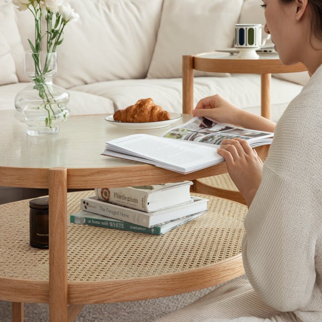 Lilian Rattan Coffee Table - Natural (Glass Tabletop) - 8 - Wooden table, beige sofa, white cup, croissant, open book