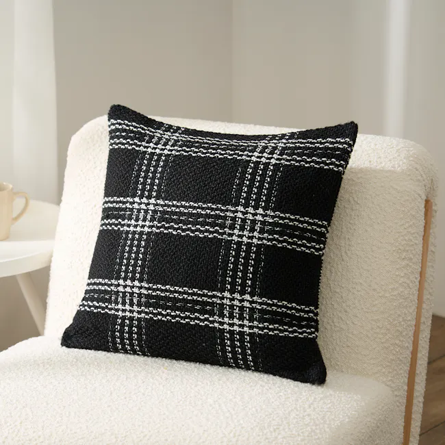 Kelsey Plaid Weaved Cushion - Black - 2 - Black and white plaid pattern, textured fabric, cozy chair, soft lighting