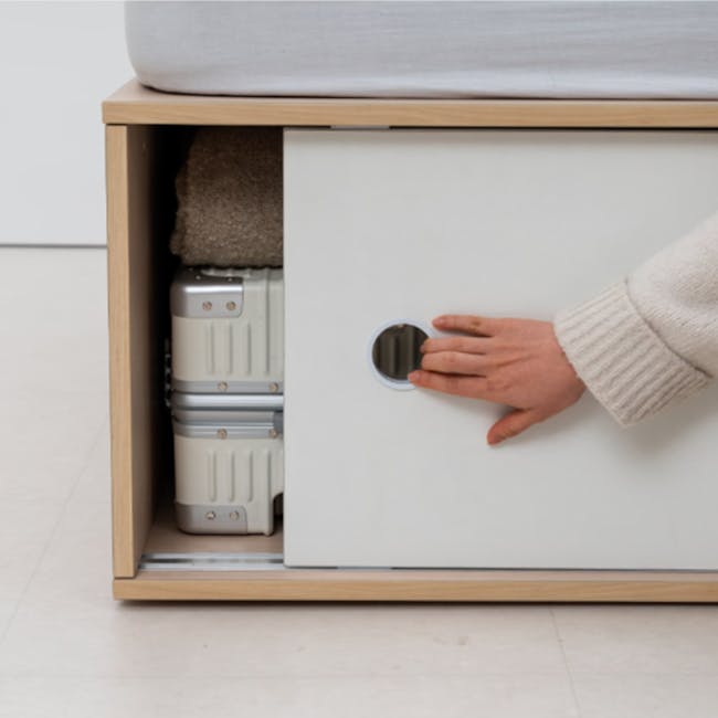 Reyna Super Single Platform Storage Bed - 7 - Wooden side table, white drawer, person's hand, suitcase drawer, neatly