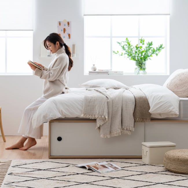 Reyna Super Single Platform Storage Bed - 4 - Sleek modern bedroom, cozy reading nook, woman in white robe, sitting on bed