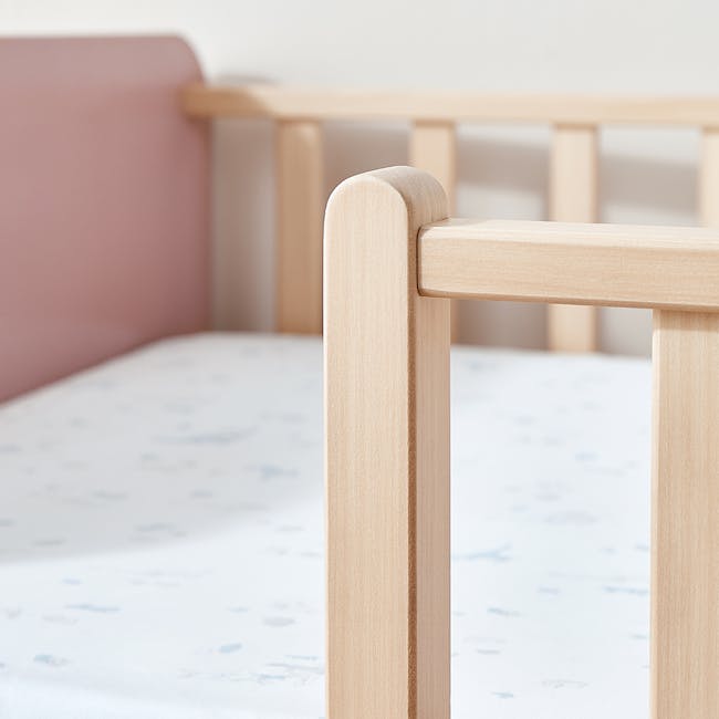 Natty Boori Bedside Bed - Blueberry & Almond - 6 - Light wooden crib frame, soft pink headboard, minimalist design, natural