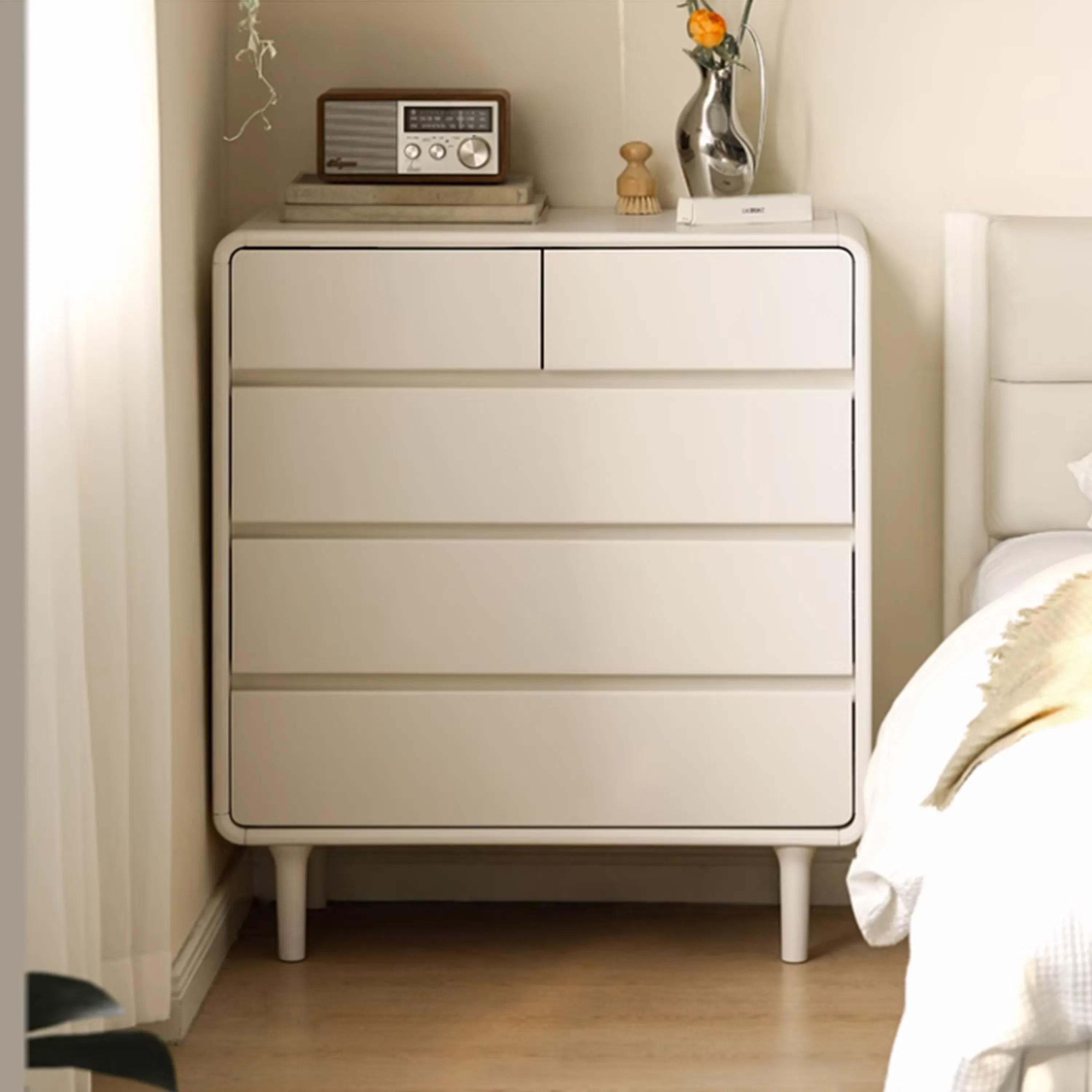 Lucy 5 Drawer Chest - 9 - White dresser with four drawers, minimalist design, vintage radio on top, wooden knobs, small vase