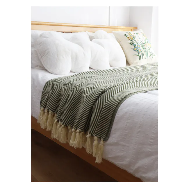 Hosanna Throw - Green - 4 - Green and white chevron-patterned throw blanket, white fluffy pillows, wooden headboard, soft