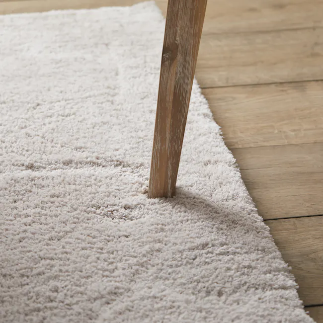 Leland Dining Chair - 5 - Shag rug, wooden floor, wooden table leg, white shag carpet, soft texture, fluffy carpet, wooden