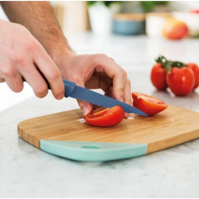 Berghoff 3 PC Multifunctional Stainless Steel Starter Knife Set - 4 - hand-cutting ripe red tomato on wooden cutting board