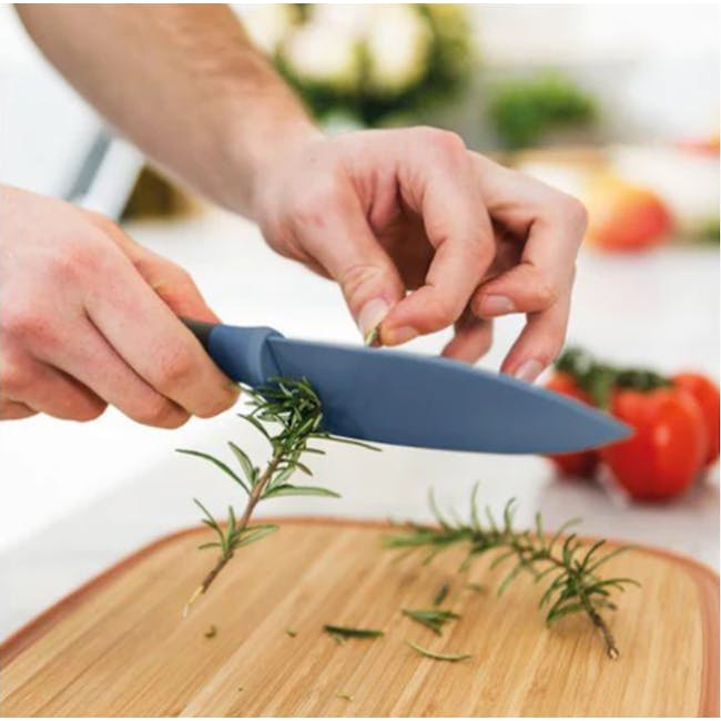 Berghoff 3 PC Multifunctional Stainless Steel Starter Knife Set - 2 - Cutting fresh rosemary on wooden cutting board, chef's