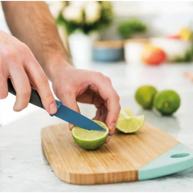 Berghoff 3 PC Multifunctional Stainless Steel Starter Knife Set - 3 - hands slicing lime on wooden cutting board, green lime