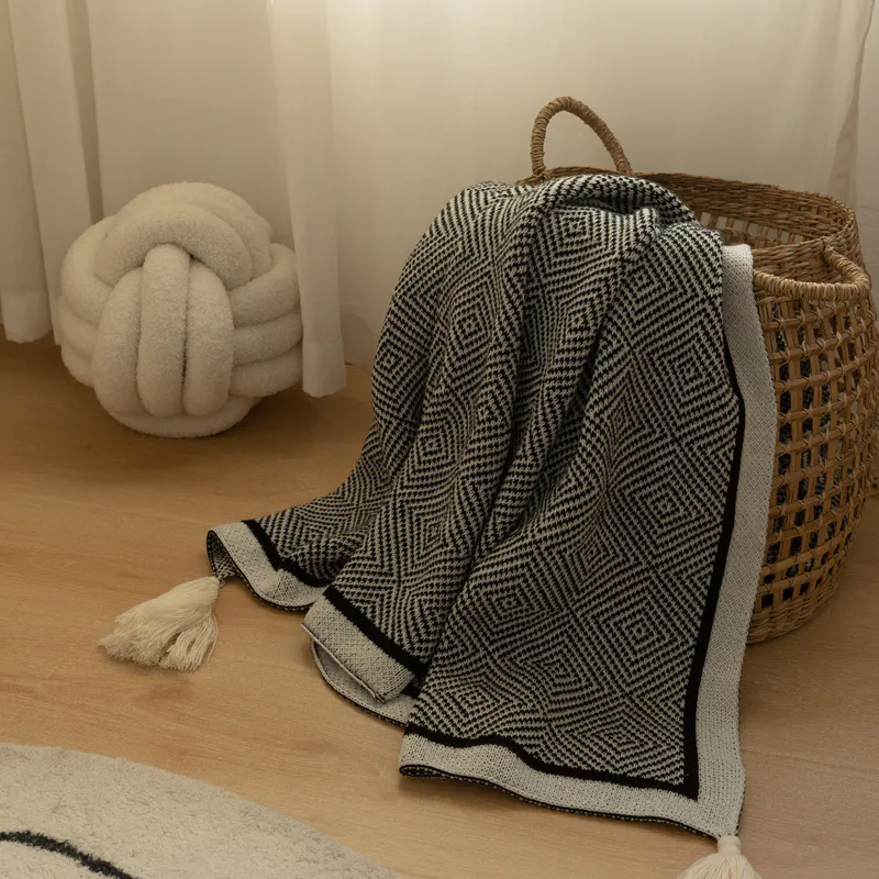 Hetty Throw - Black, White - 10 - Cream and black houndstooth patterned throw blanket, cream-colored tassel, wooden floor