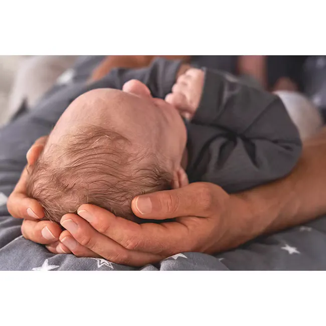 Theraline The Original Maternity and Nursing Pillow - Misty Blue Fine Knit - 13 - Newborn baby cradled in loving hands, gray