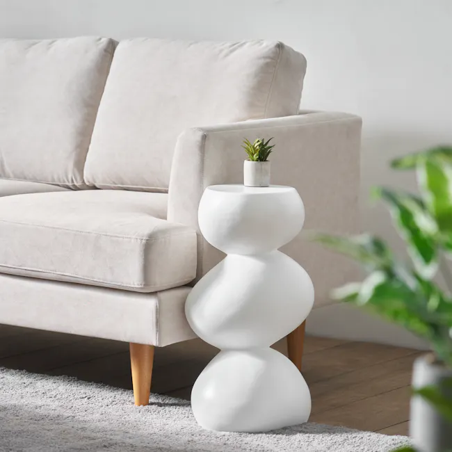 Stack Sculptural Concrete Side Table - Ivory - 2 - Cream-colored sofa, minimalist side table, green potted plant, soft