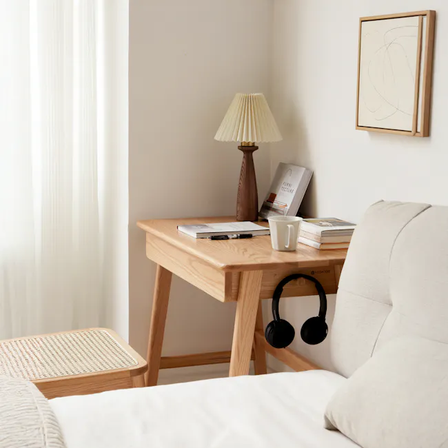 Chase Study Table 0.7m - 12 - Wooden desk, beige lamp, white cup, books, headphones, beige cushion, light-colored wall