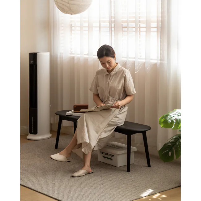Felda Bench 1.4m - Black Ash - 11 - Softly lit room, woman reading, light curtains, modern decor, beige dress, white air
