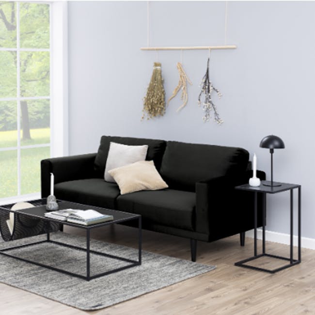 Fraser Side Table - 12 - Modern minimalist living room, cozy black sofa, natural light streaming through window, light gray