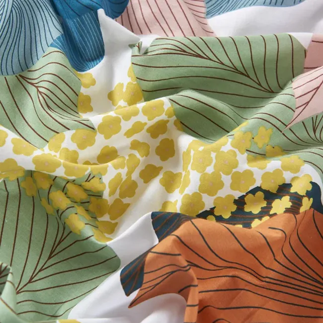 Carla 5-pc Cotton Bedding Set (4 Sizes) - 4 - Floral print fabric, vibrant yellow flowers, green leaf patterns, abstract