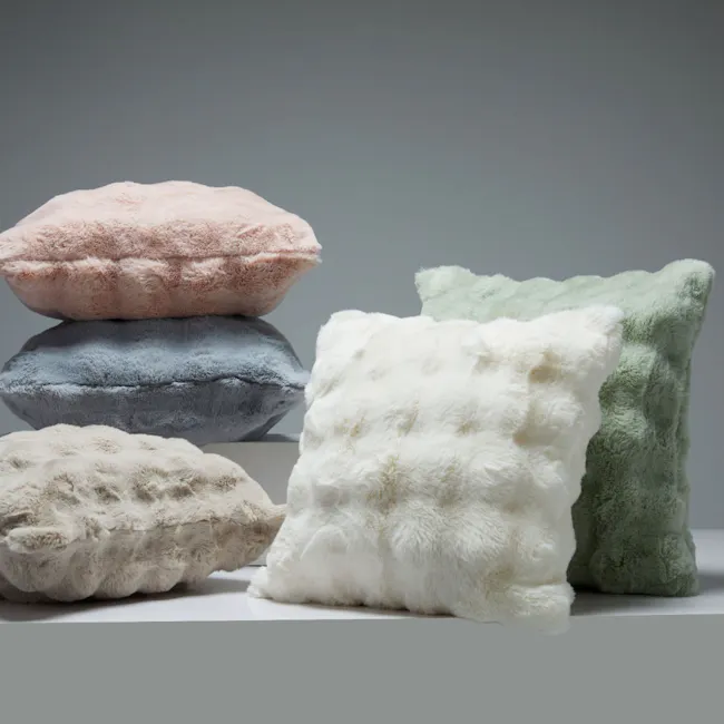 Luxe Faux Fur Cushion - White - 6 - Soft, fluffy pillows in pastel colors, including pink, blue, white, and green, stacked