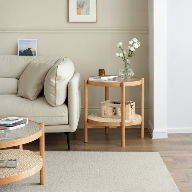 Lilian Rattan Coffee Table - Natural (Glass Tabletop) - 5 - Cream-colored sofa, wooden side table, white ceramic mug, woven