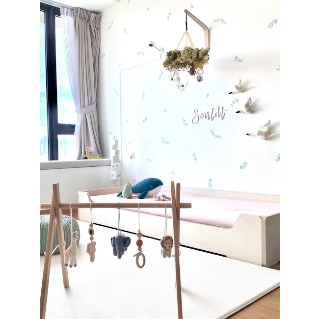 Urban Li'l Eucalyptus Fabric Decal - 4 - Soft, pastel-colored nursery room, cozy and inviting atmosphere, baby's crib with